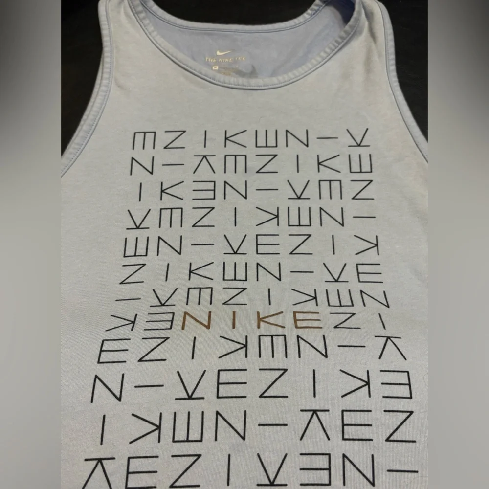 Nike light blue tank top with logo pattern. Size Medium.